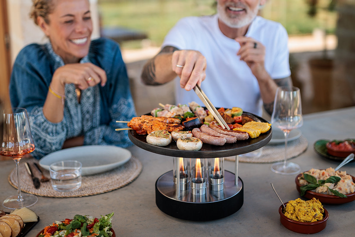 CIRCLE 35 Tabletop Grill in use with open flame at a table setting