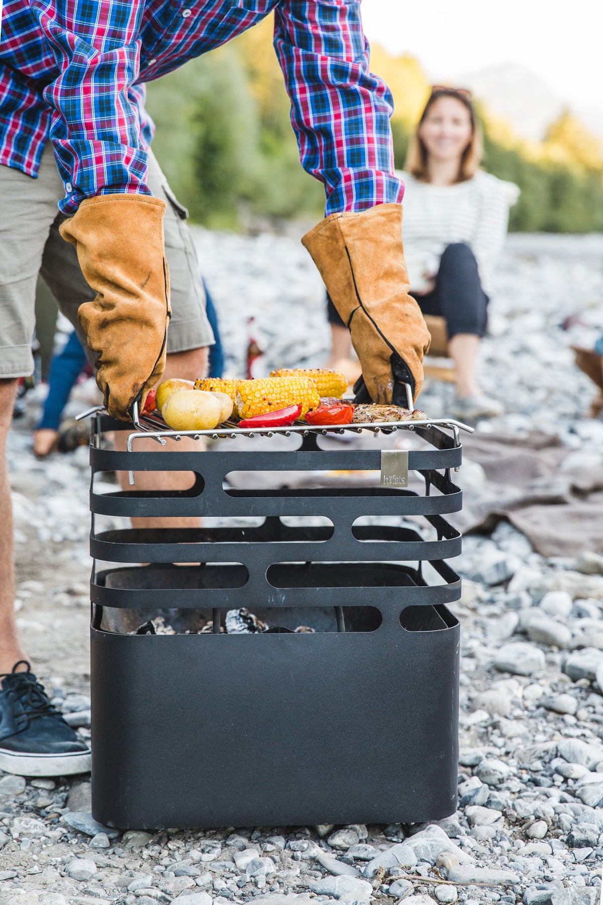 Cooking outdoors on the CUBE Fire Basket fitted with the CUBE Cooking Grid