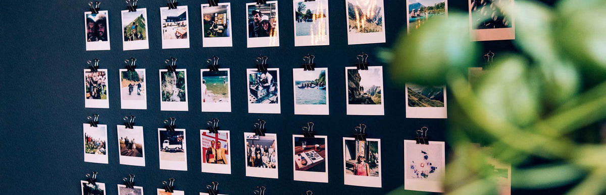 A wall covered in polaroid photos of the höfats team